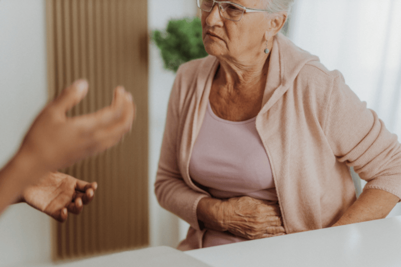 Senior woman visiting her doctor to discuss health concerns. 