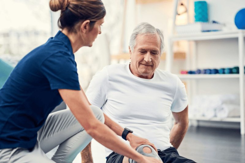 Female physiotherapist working with a senior male patient.