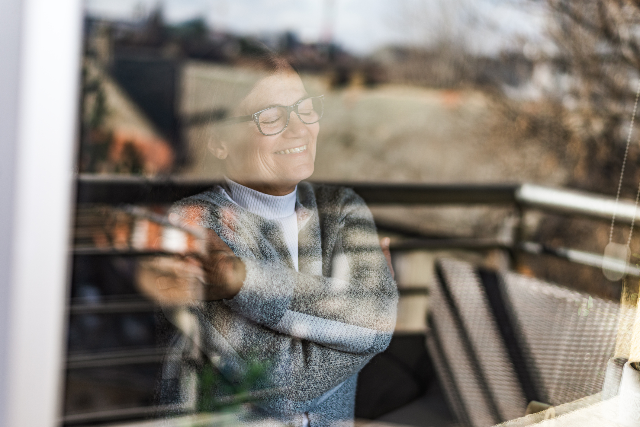 woman looking in a window smiling