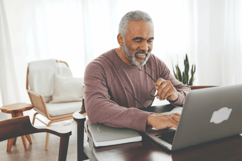 Mature male using laptop computer.