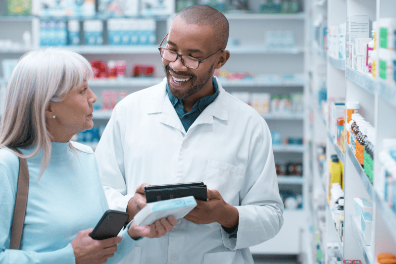 Pharmacist helping female patient choose the right medication.
