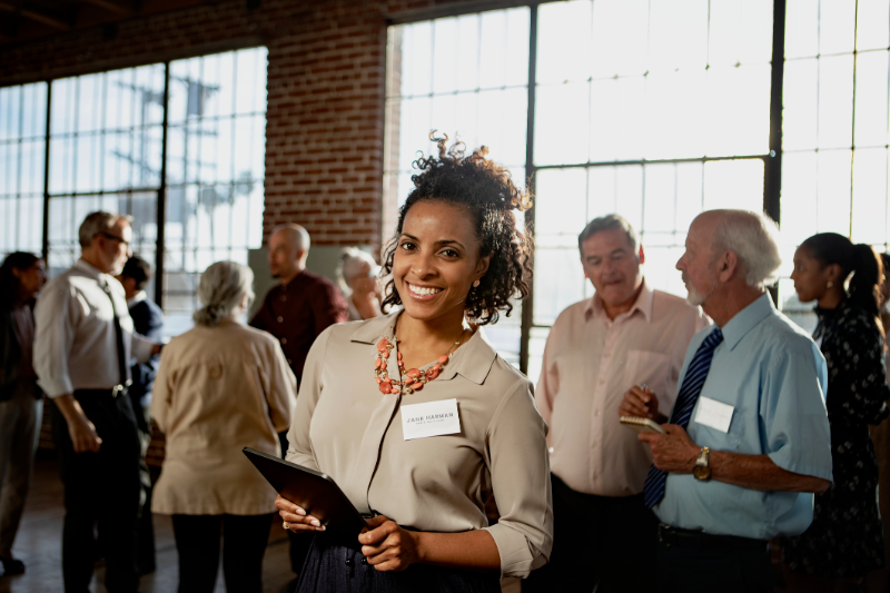 Woman in a crowded office smiling