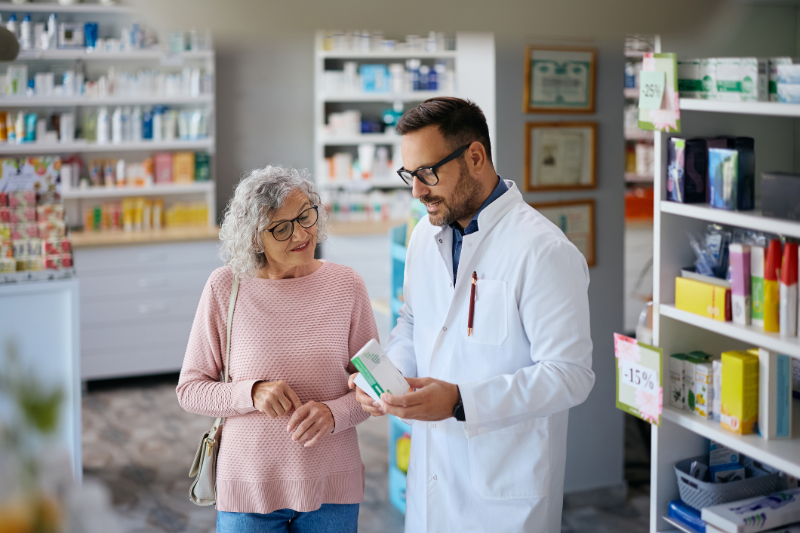 Senior woman speaking with a pharmacist