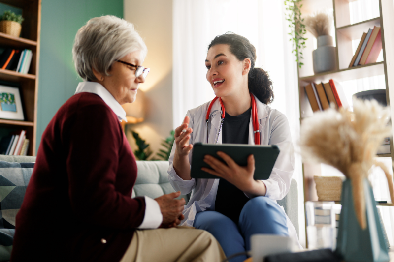 Senior woman sitting talking to her provider