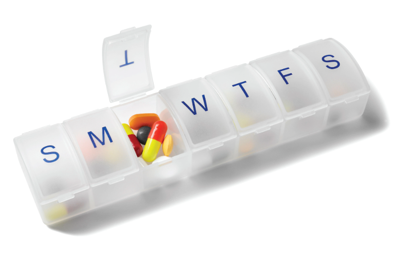 White medicine organizer filled with the Tuesday section open