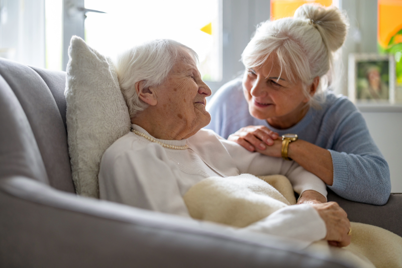 Caregiver sitting with an older woman