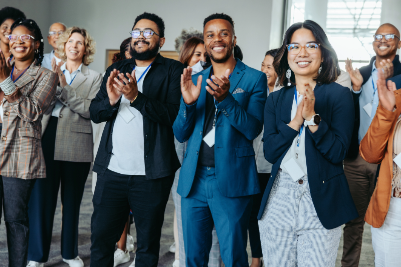 Business professionals in an office clapping