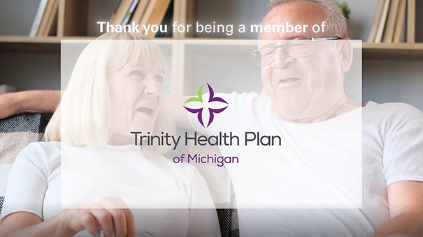 Trinity Health Plan of Michigan logo over a senior couple sitting on a couch